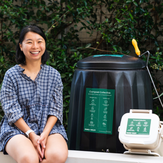 Composter sitting next to compost bin